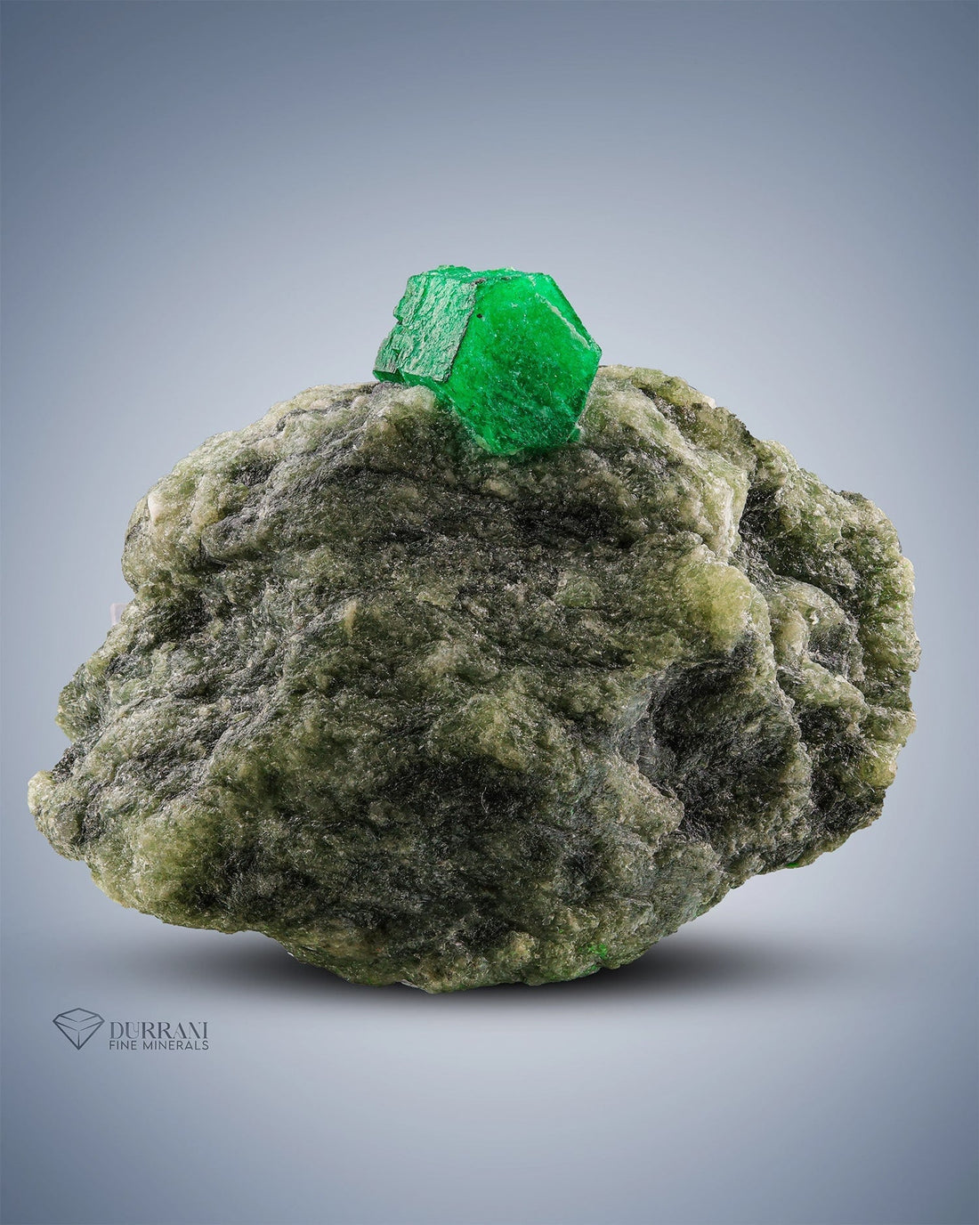 Green emerald crystal on matrix
